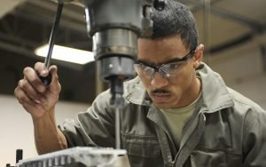 Worker operating a drilling machine